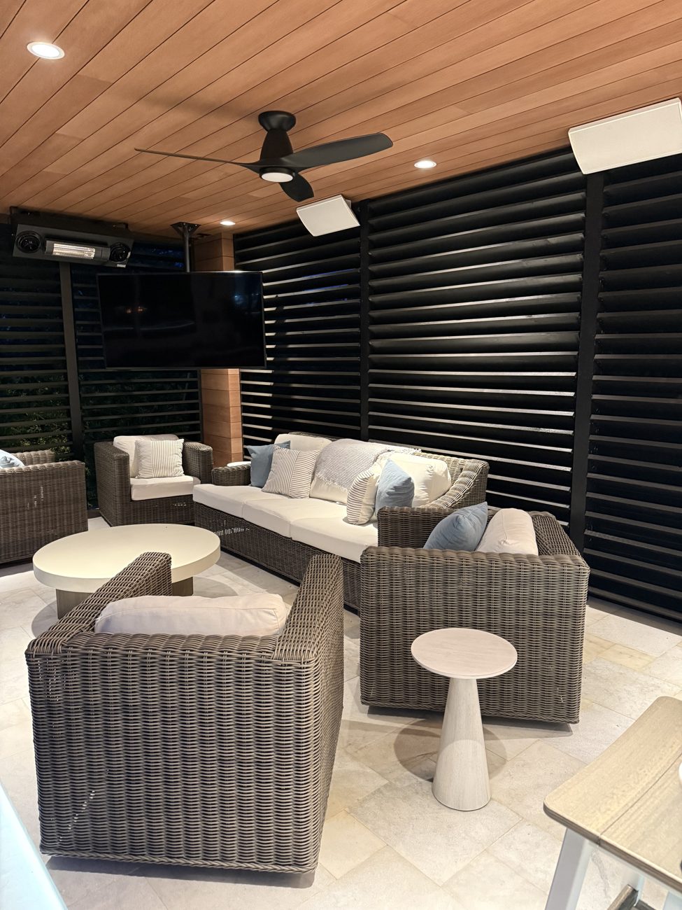 Custom covered outdoor living area with recessed architectural lighting